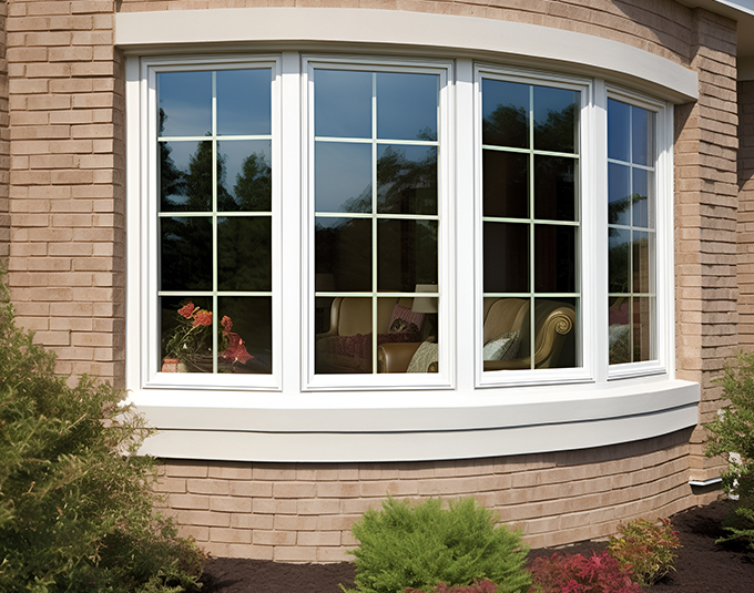 windows from the outside with white frames on a curved section of a home